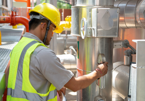 asian-engineer-wearing-glasses-working-boiler-roommaintenance-checking-technical-data-heating-system-equipmentthailand-people 1
